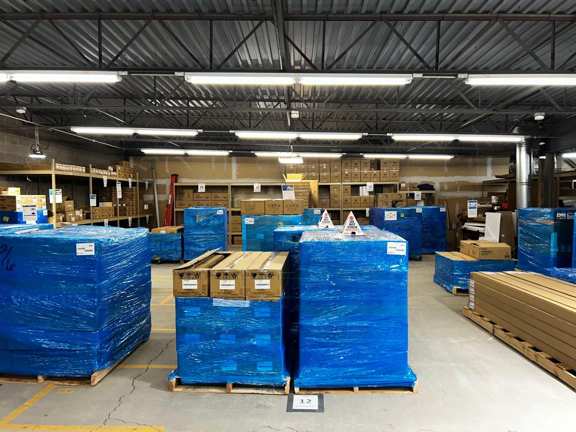 Racked lighting inventory inside the All Electric Sales warehouse in Addison, Illinois